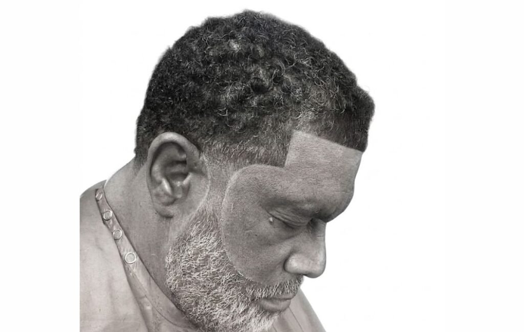 An older man with temple fade haircut