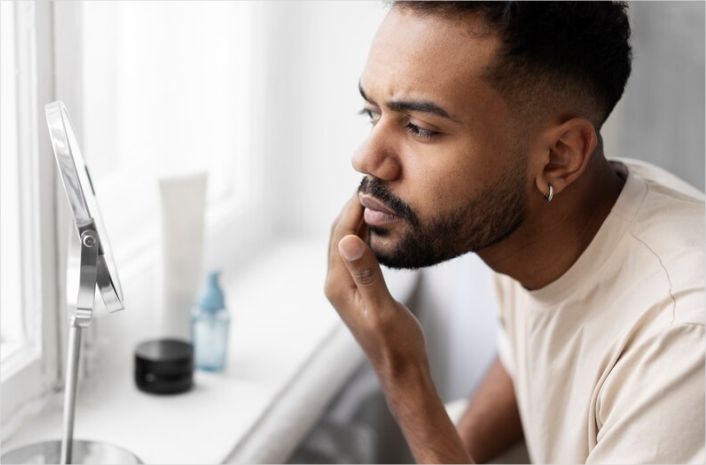 A man hit with the common Skincare Mistakes Men Make