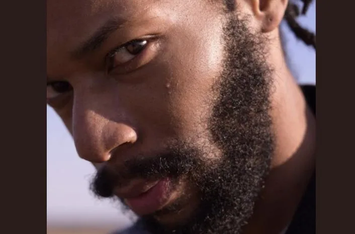 A man showing his facial hair growth