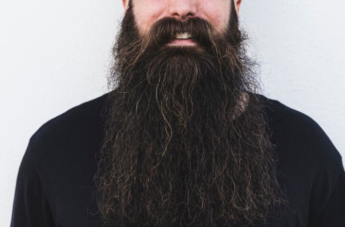 A man wearing a thick full beard