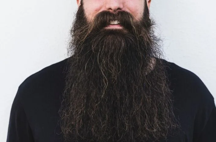 A man wearing a thick full beard