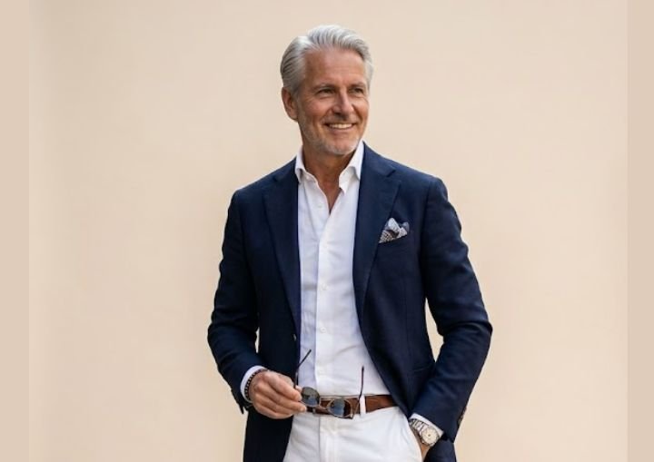 An older man in navy blue blazers