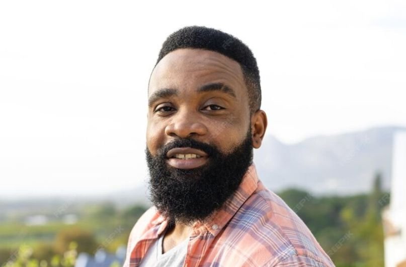 A young man with full beard answer the question - When Do Men Start Growing Full Beards?