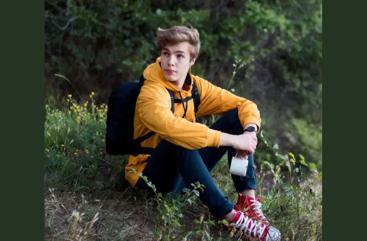 A man in his 20s hiking