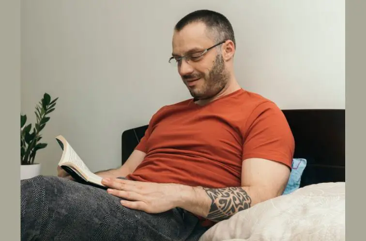 A man in his 40s reading a book as his hobby