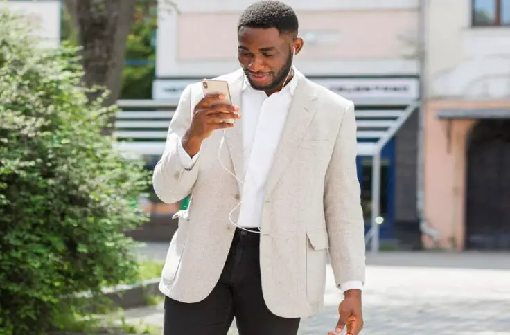 A man styles his blazer with a tailored trousers