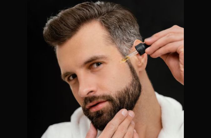 A man applying Beard Oils for Patchy Beards