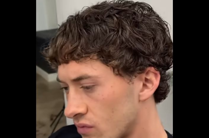 A man getting a Caesar haircut