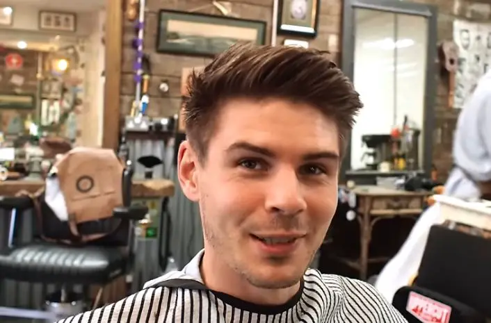 A young man with a fresh crew cut