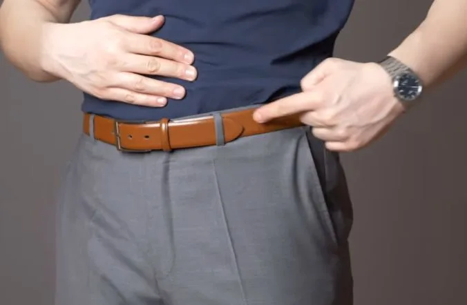 A man wearing a brown belt to demonstrate men's belts guide