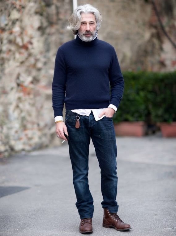 A man in his 60s wearing a Dark Jeans with a Turtleneck and Boots