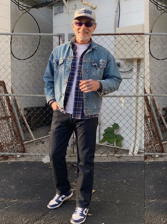A 60s man in a Straight Jeans Layered Under a Contrast Denim Jacket