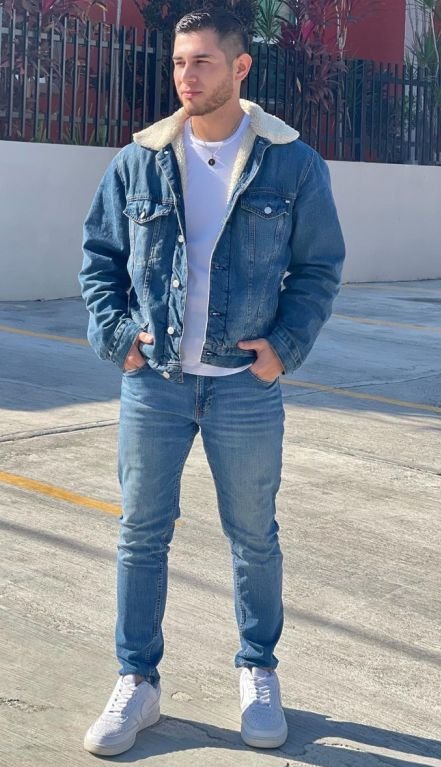 A man putting on Denim on Denim With a Suede Jacket for Cooler Weather