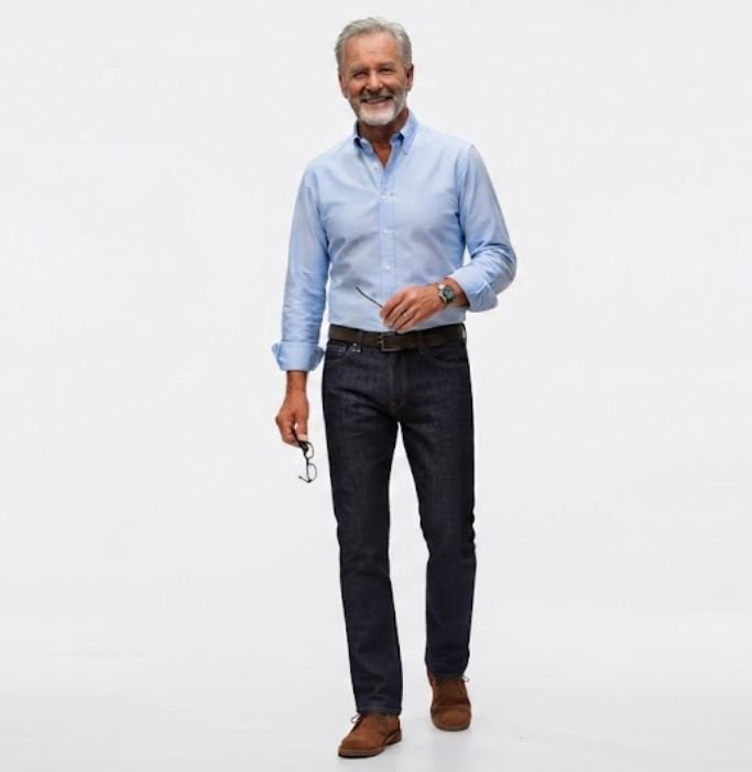 Older man in a classic out of Oxford Shirt, Dark Denim, and Suede Desert Boots