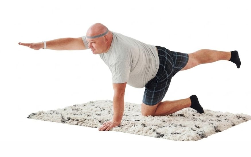 A man doing Bird-Dog Exercise for full-body workout for older men