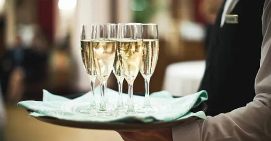 A butler as a gentleman's gentleman taking drinks to the master