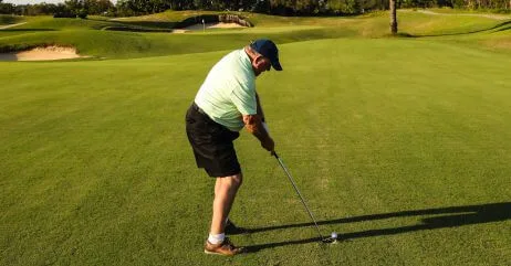 An older man playing golf as a hobby