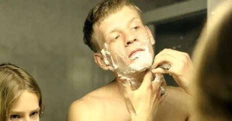 A man and son shaving beards