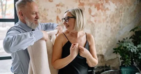 A man offering a lady a coat in a gentleman's style of leisure