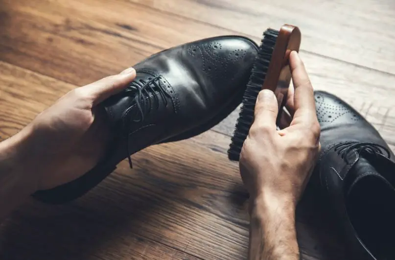 Polishing a dress shoe and shining with a brush