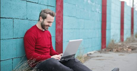 A happy man chatting with his online date