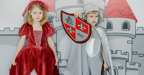 A child dressed in the knight's kit with a noble young woman by the side, depicting the training of knights