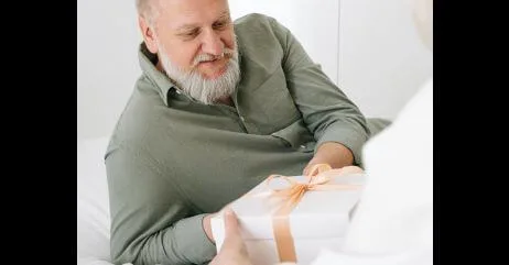 An older man receiving a gift