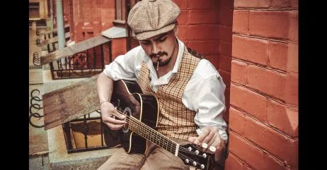 An elegant gentleman playing guitar