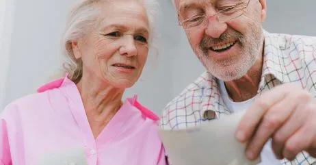 An elderly man happy after receiving a gift of handwritten appreciation