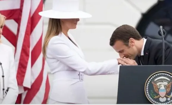 A man kissing a woman's hand