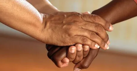 Using two hands to shake an older person a cultural practice of handshake etiquette